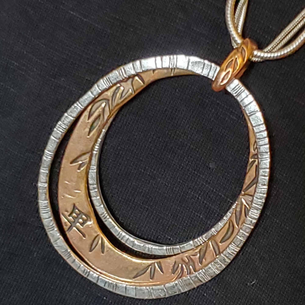 Chico's three strand silvertone snake chain with two tone Chinese symbols
